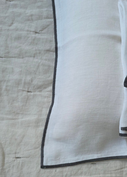 Textured fabric with a black border on a beige background
