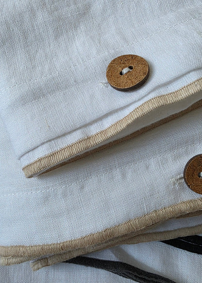 Close-up of a textured fabric with buttons and a striped pattern