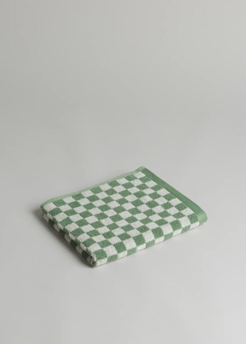 Green and white checkered towel on a light gray background
