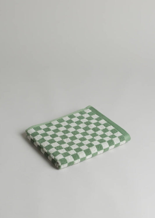 Green and white checkered towel on a light gray background