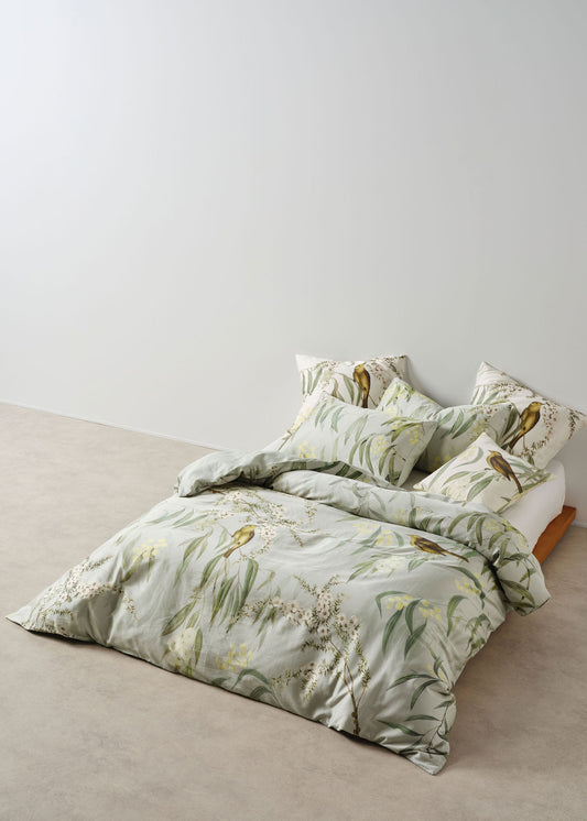Floral bedding set on a bed against a white wall