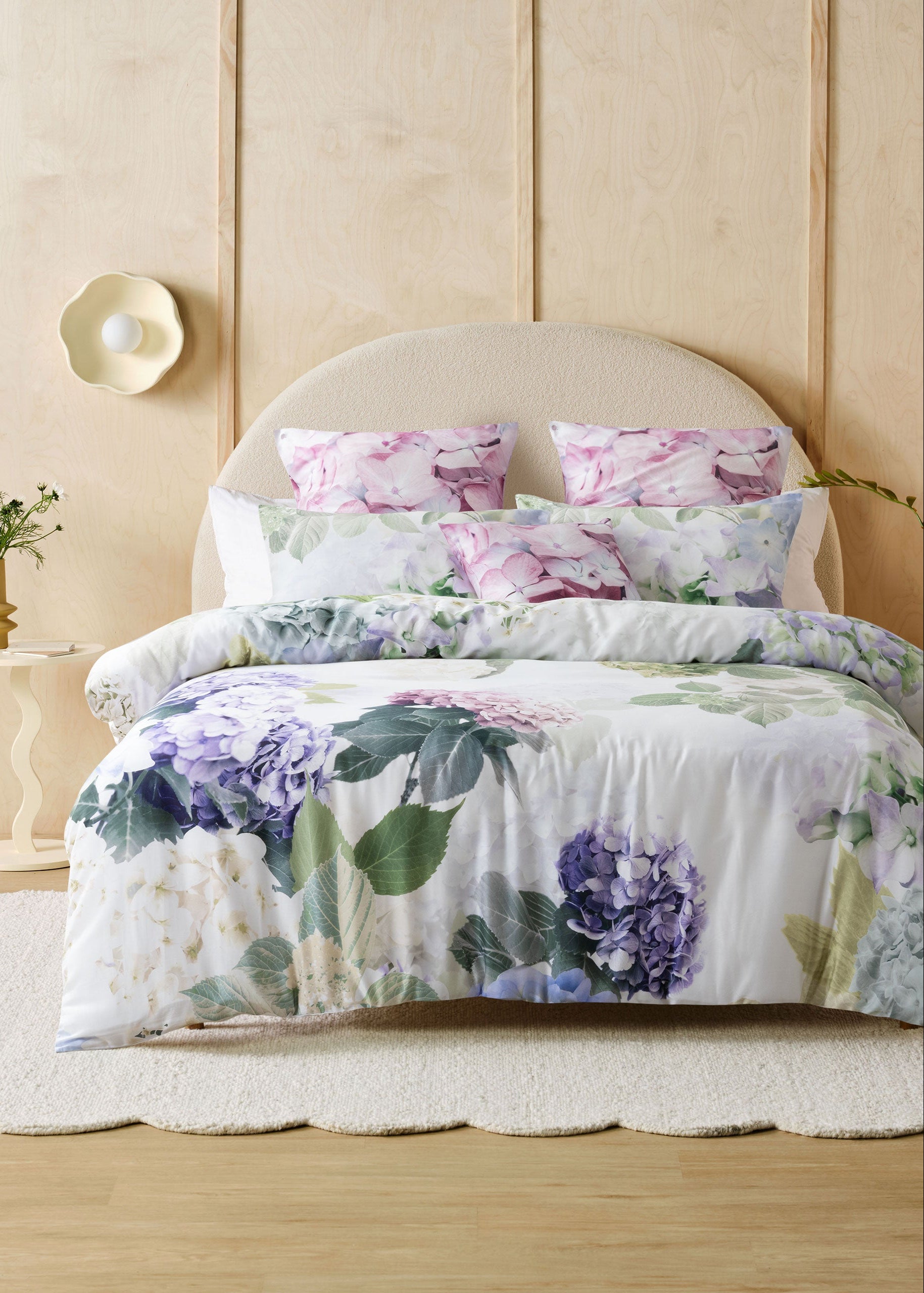 Floral bedding set on a bed with a neutral headboard