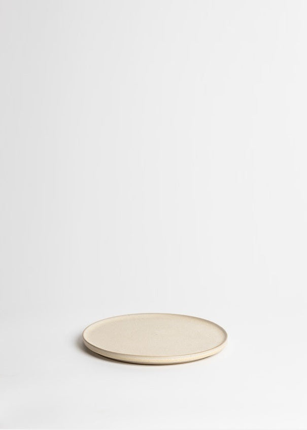 Beige ceramic plate on a white background