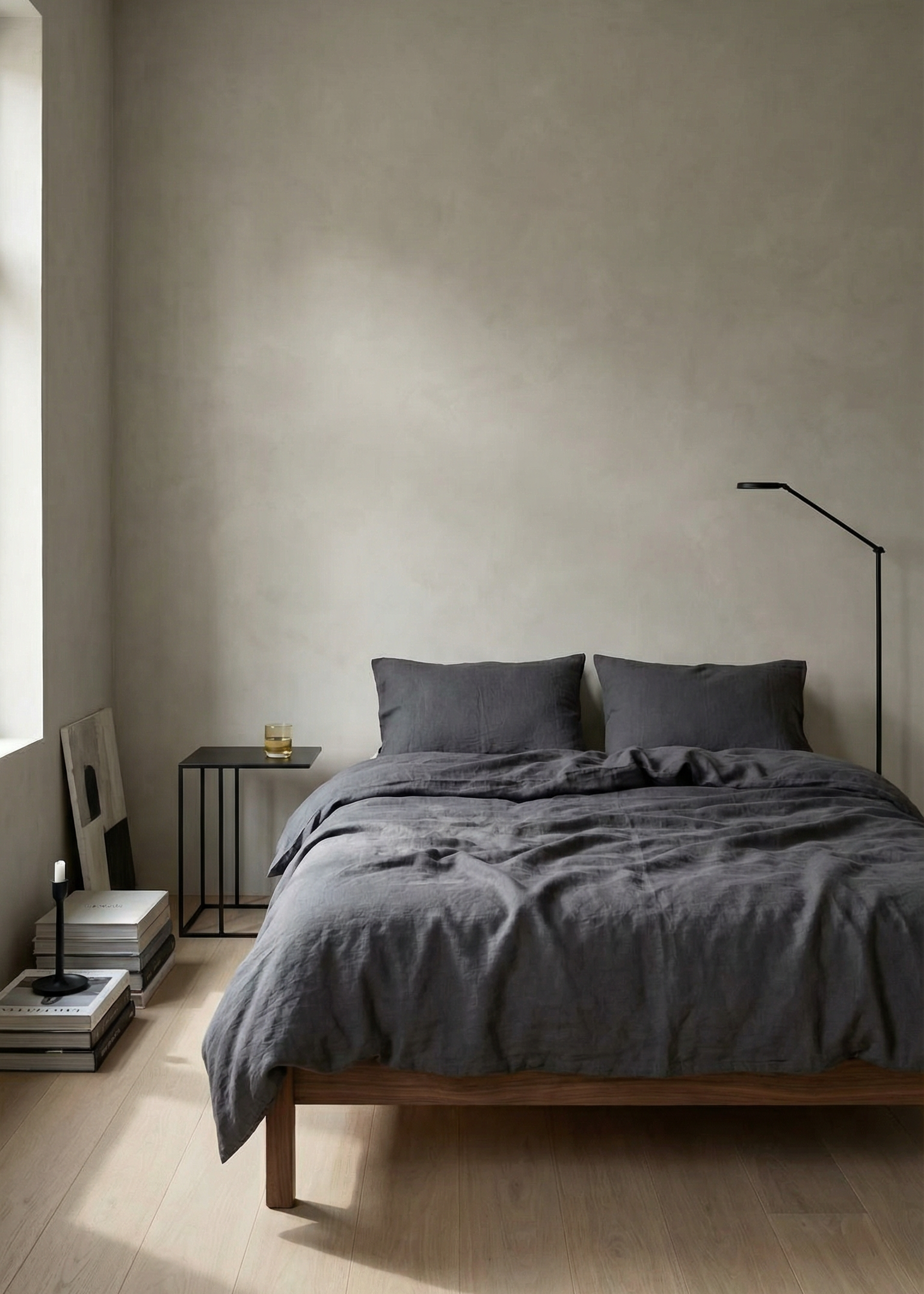 Minimalist bedroom with gray bedding and neutral walls