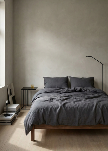 Minimalist bedroom with gray bedding and neutral walls