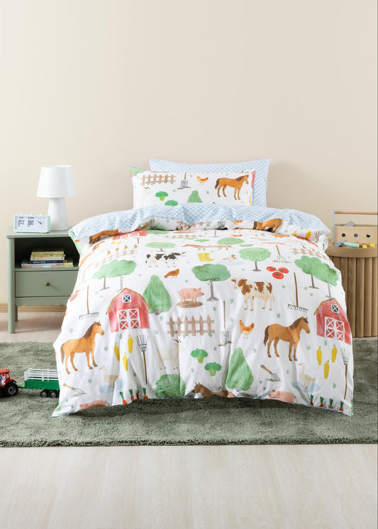 Children's bed with farm-themed bedding in a room setting.