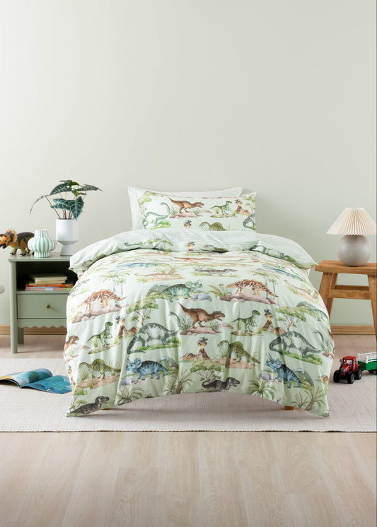 Bed with dinosaur-themed bedding in a bedroom setting