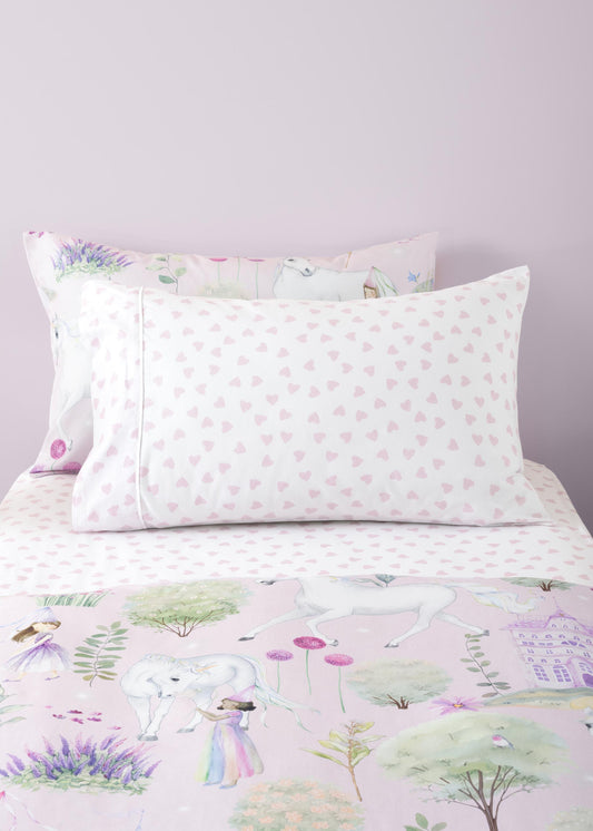 Floral and nature-themed bedding set with pillows on a bed.