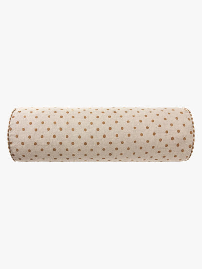 A cylindrical bolster pillow with a beige fabric cover featuring a repeating pattern of small brown polka dots, shown against a plain white background.