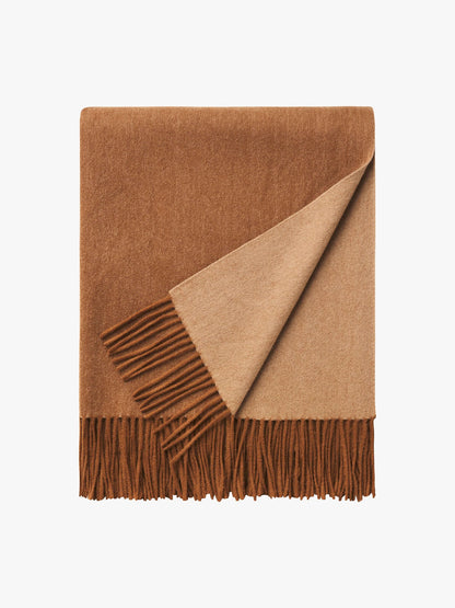 Brown and beige blanket with fringes on a white background