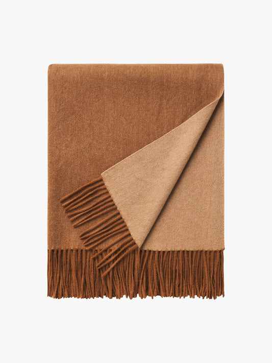 Brown and beige blanket with fringes on a white background