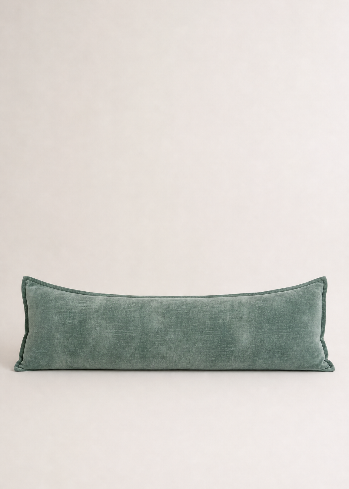 Green pillow on a light gray background
