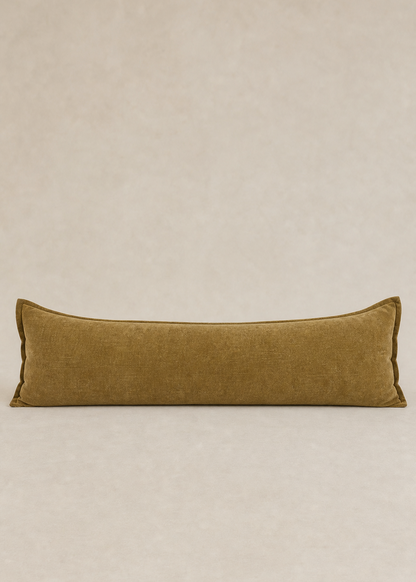 Long rectangular brown pillow on a beige background