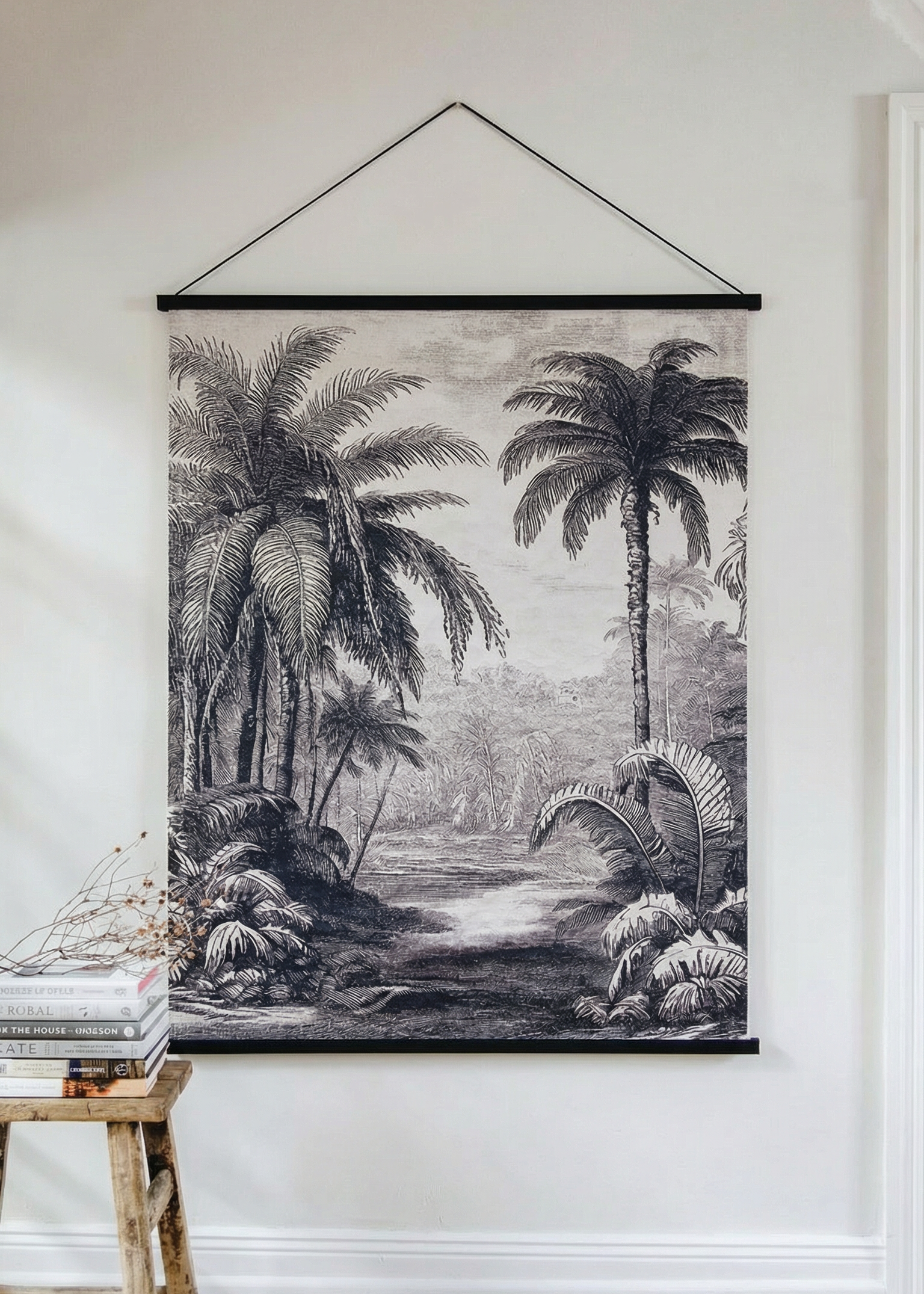 Tapestry with a tropical landscape design hanging on a wall.