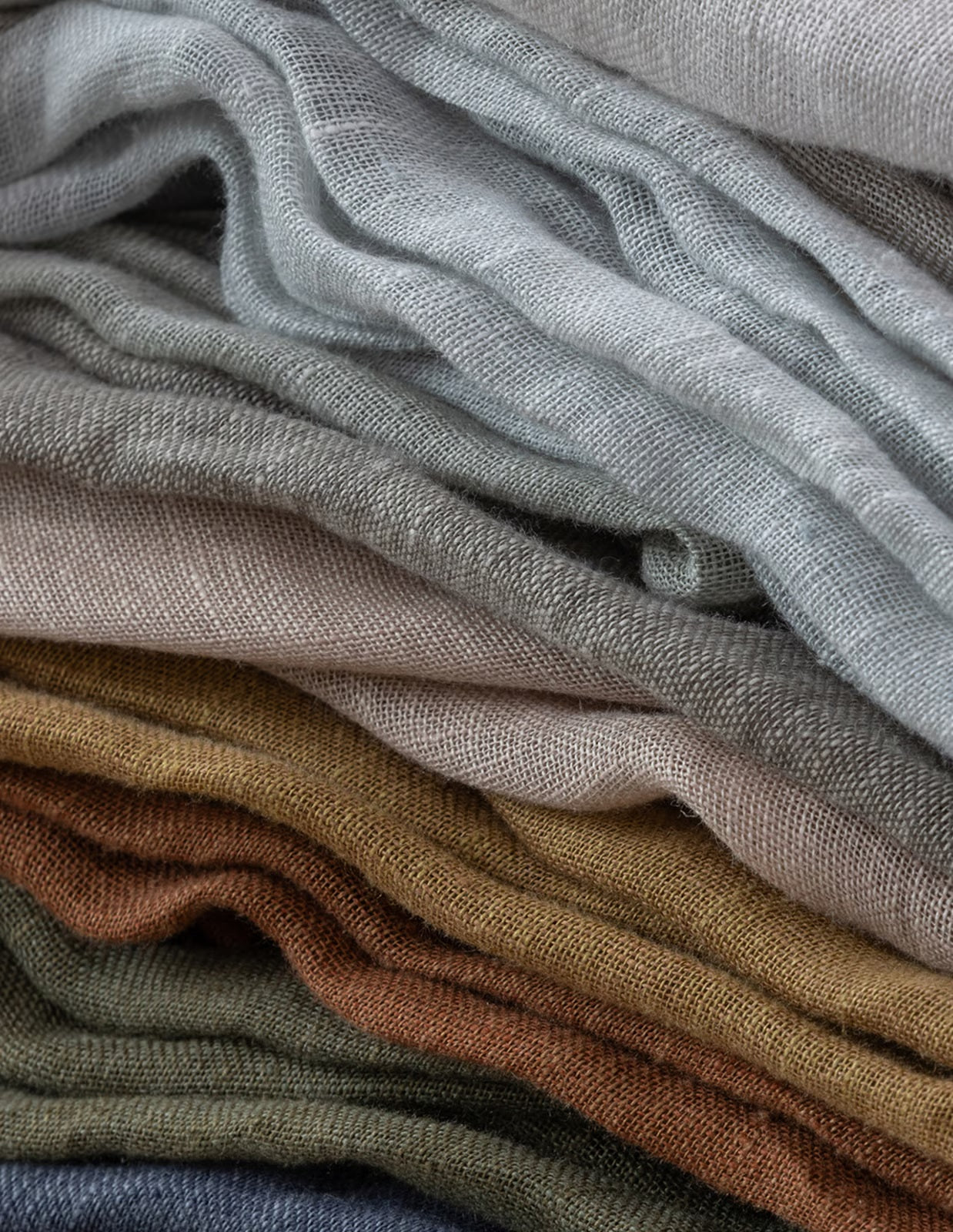 Stack of folded fabric in various neutral colors