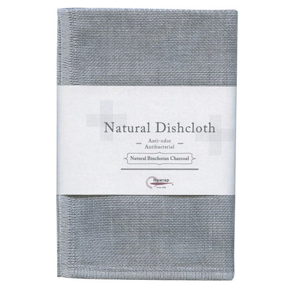 A gray dish cloth made of binchotan charcoal, displayed with a label that reads 'Natural Dishcloth' and other details.